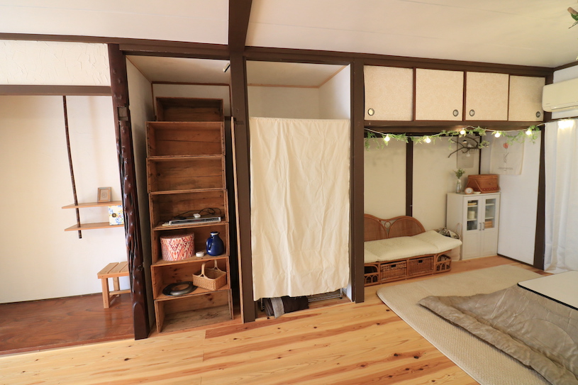 The living room has many storage shelves for common use. 